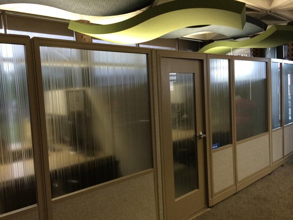 Glass film banner in office window promoting film barrier for privacy in an office