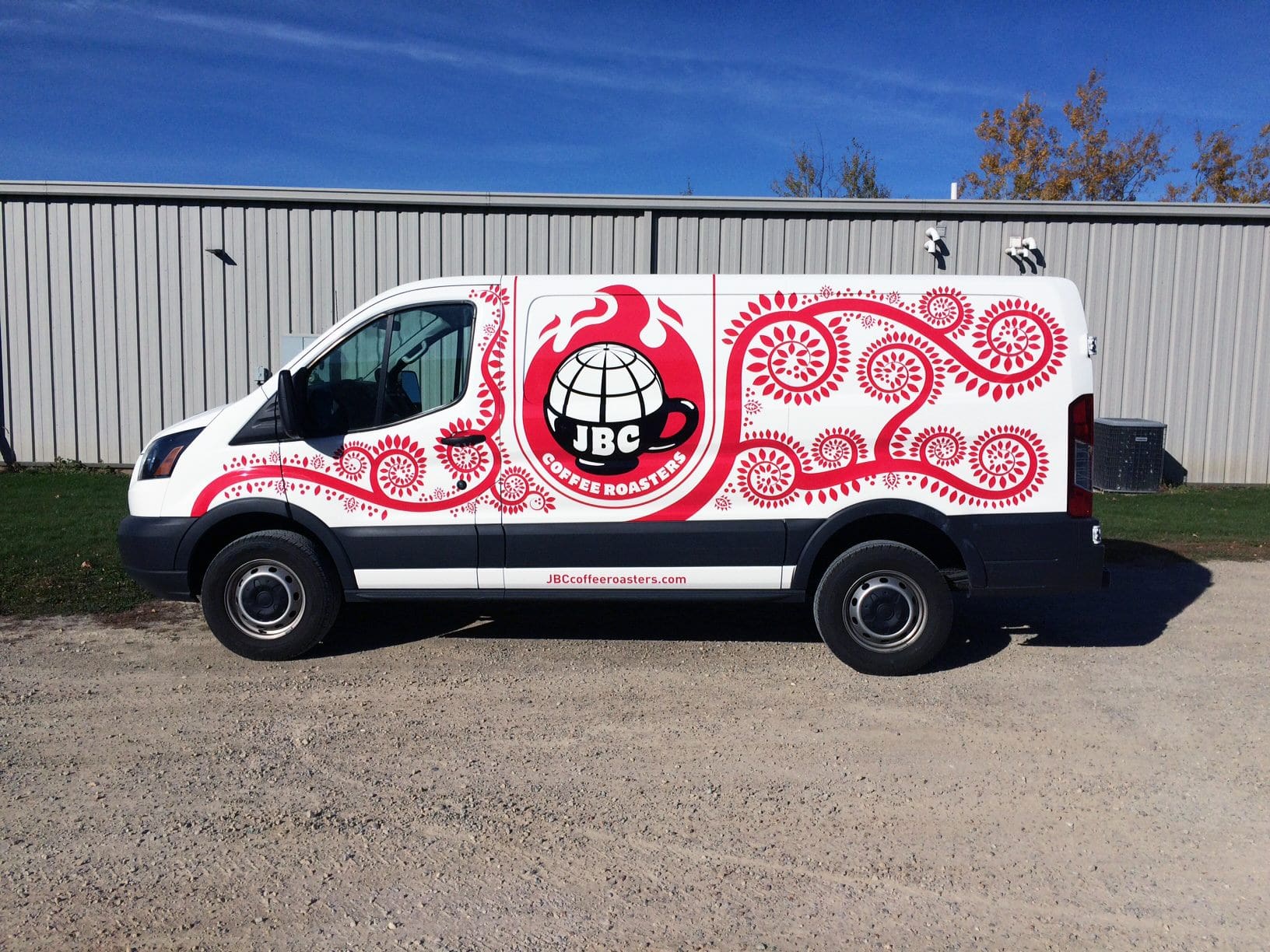 Red and white Fleet Graphics Vehicle wrap on a coffee roasters company van featuring a cup of coffee