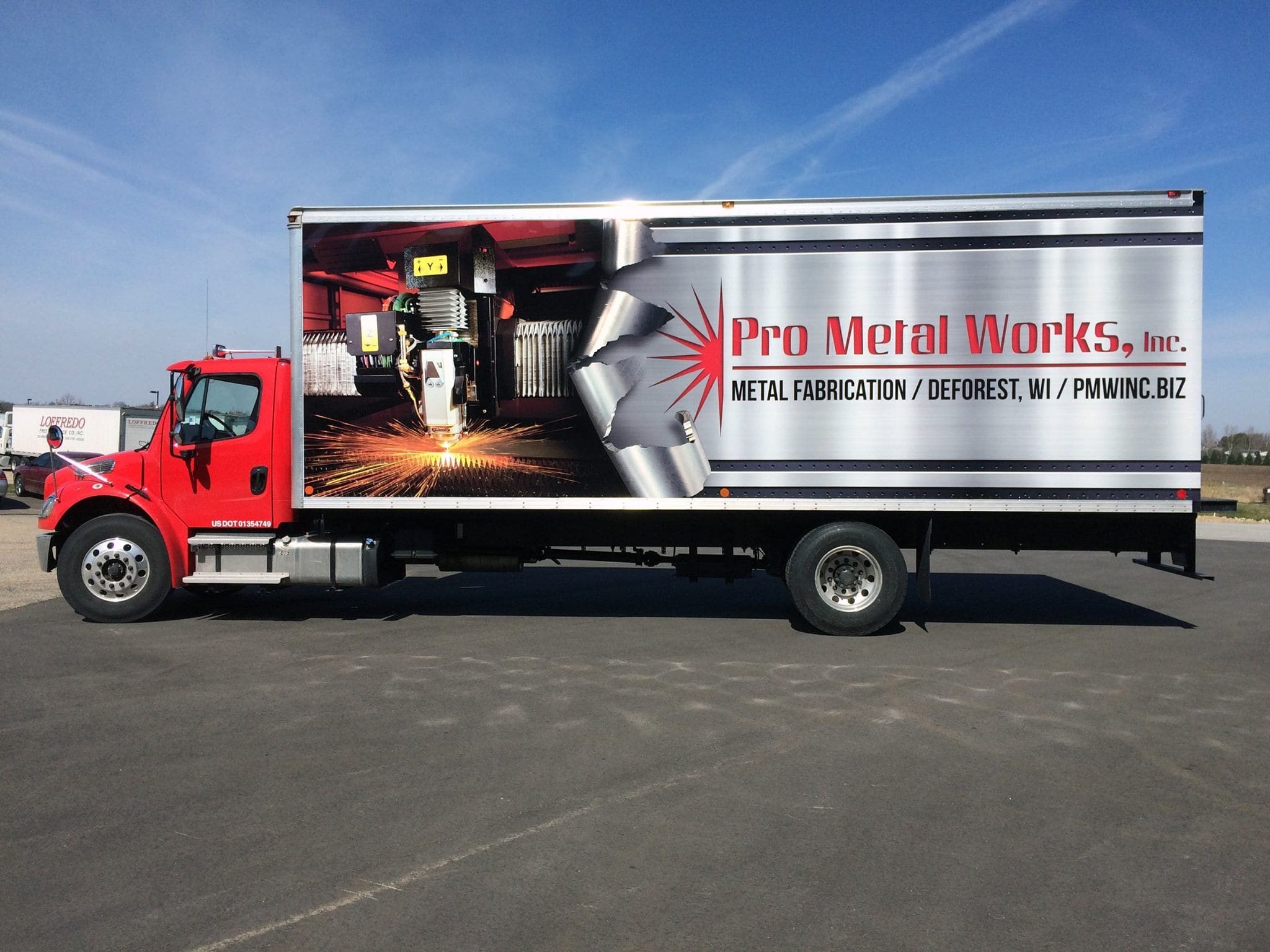 Pro metal works large company moving van Patio pleasures van with Fleet Graphics Vehicle wrap designed by Madison Graphics Company parked in front of the design building