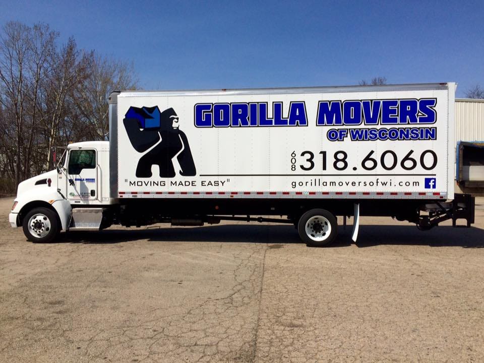 Gorilla Movers large moving truck Patio pleasures van with Fleet Graphics Vehicle wrap designed by Madison Graphics Company parked in front of the design building