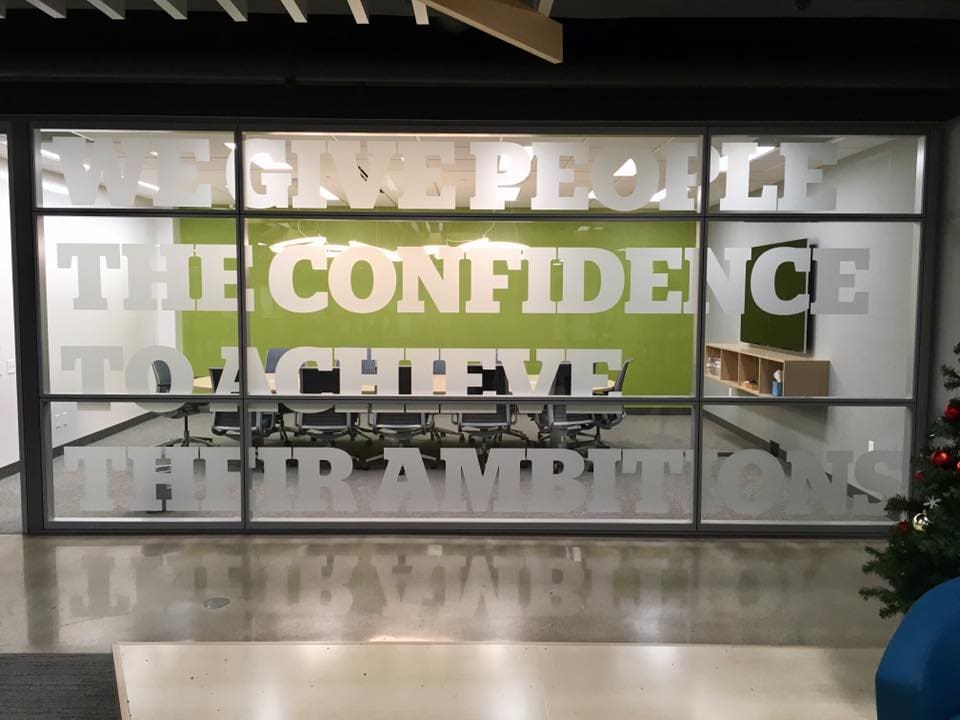 Glass film banner on the viewing wall of a conference room with the saying 