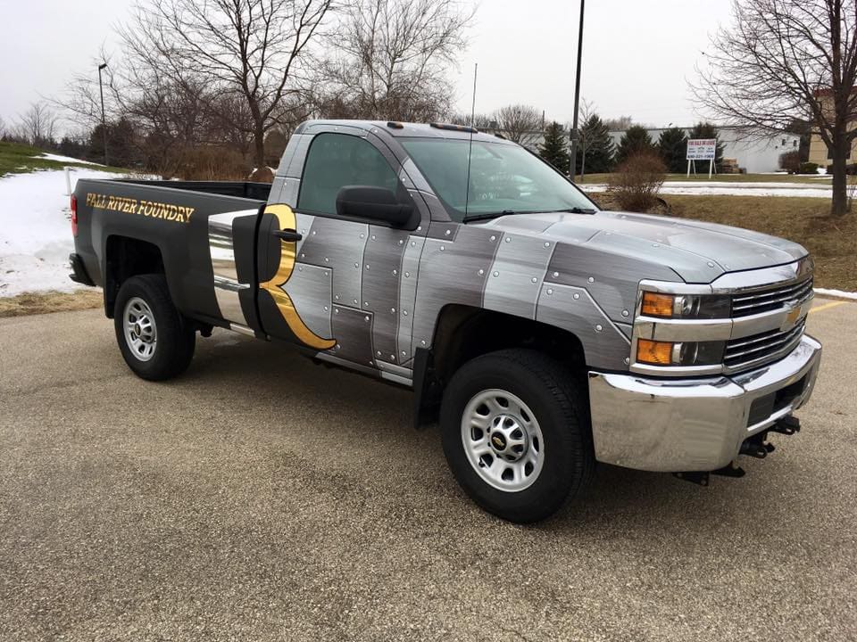 Silver plate graphics and gold lettering on a company with Fleet Graphics Vehicle wrap designed by Madison Graphics Company