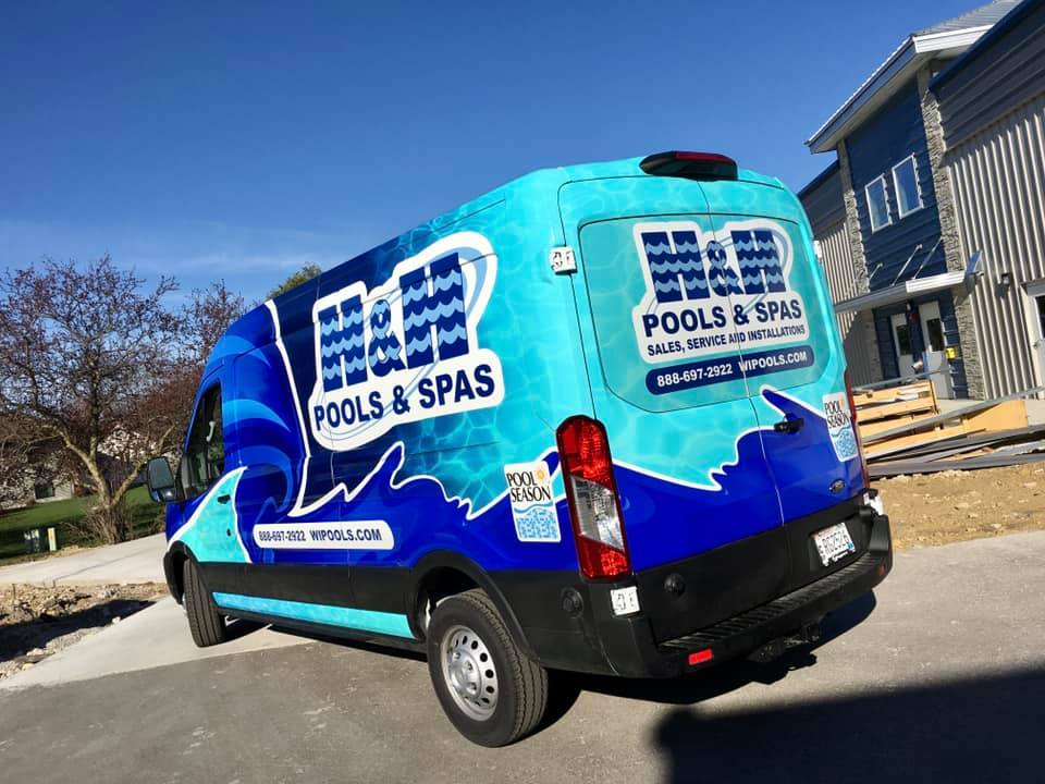 Bright blue Van with fleet vehicle wrap graphic promoting a pool and spa service