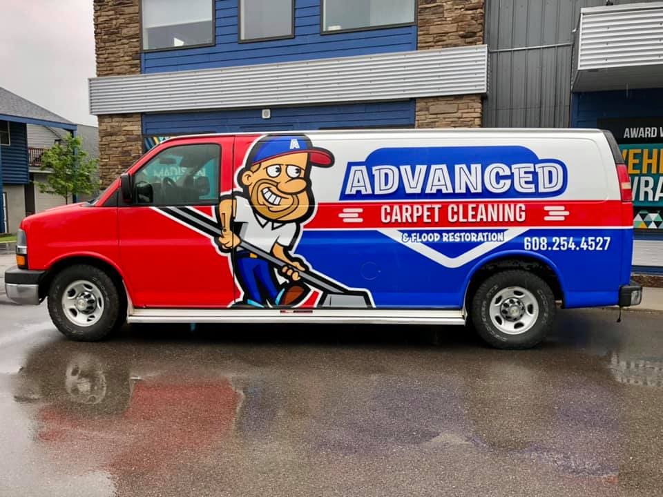Advanced carpet cleaning Van with fleet vehicle wrap graphic promoting a service with a cartoon worker and phone number on the side