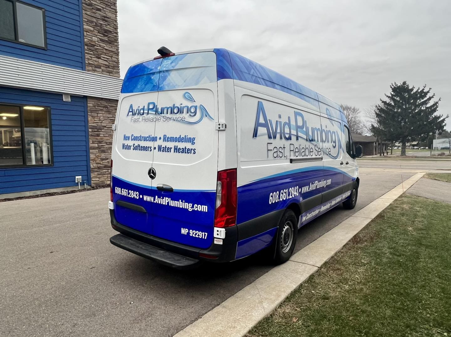 Plumbing van with fleet vehicle wrap graphic promoting construction, remodeling, and repairs