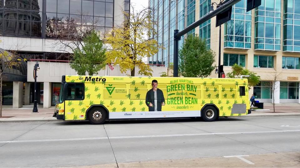 Yellow Bus Fleet Graphics promoting a business on the metro bus