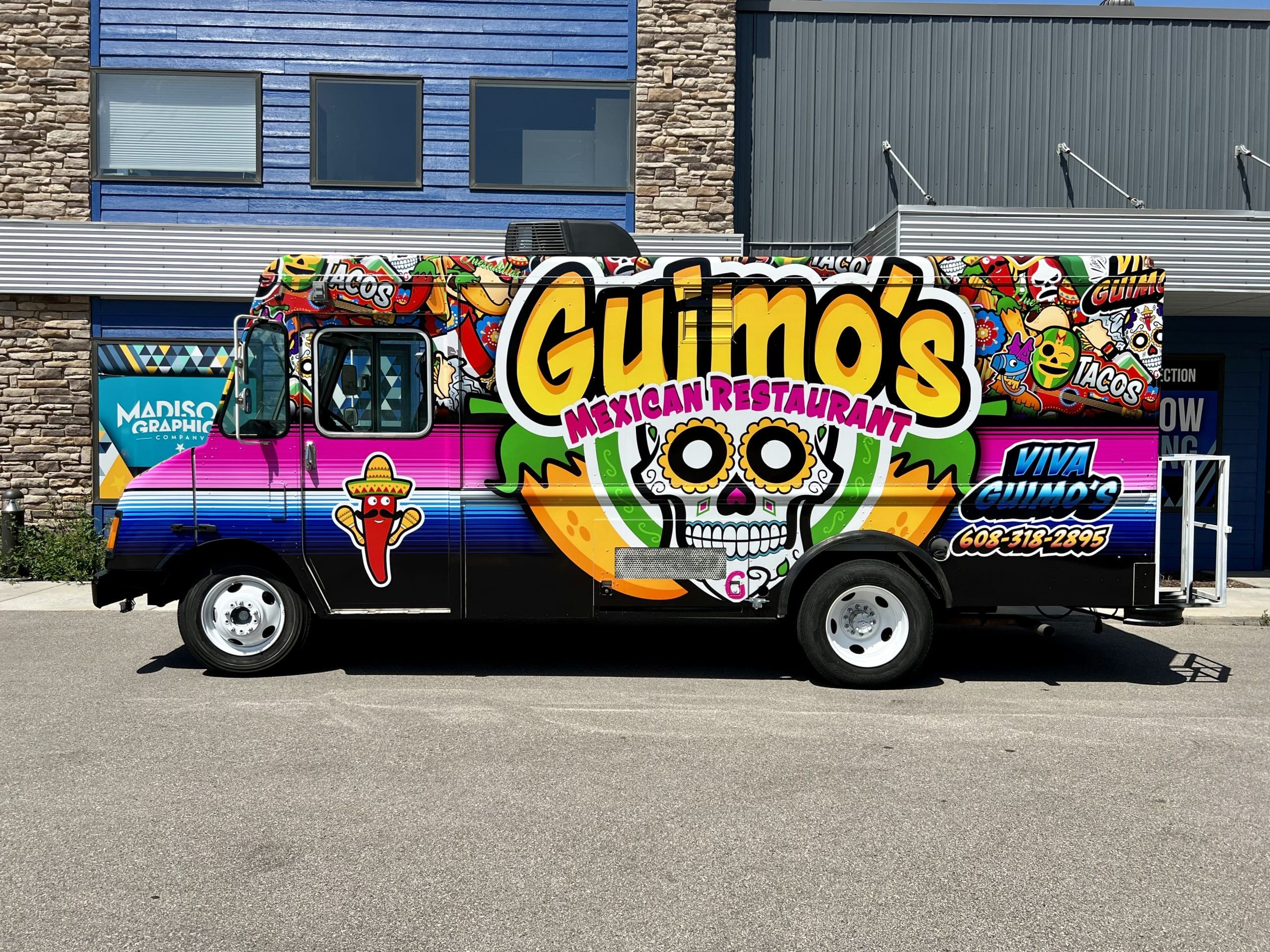 Mexican restaurant food truck with fun vehicle wrap with a Mexican skull cartoon and chili shaking maracas