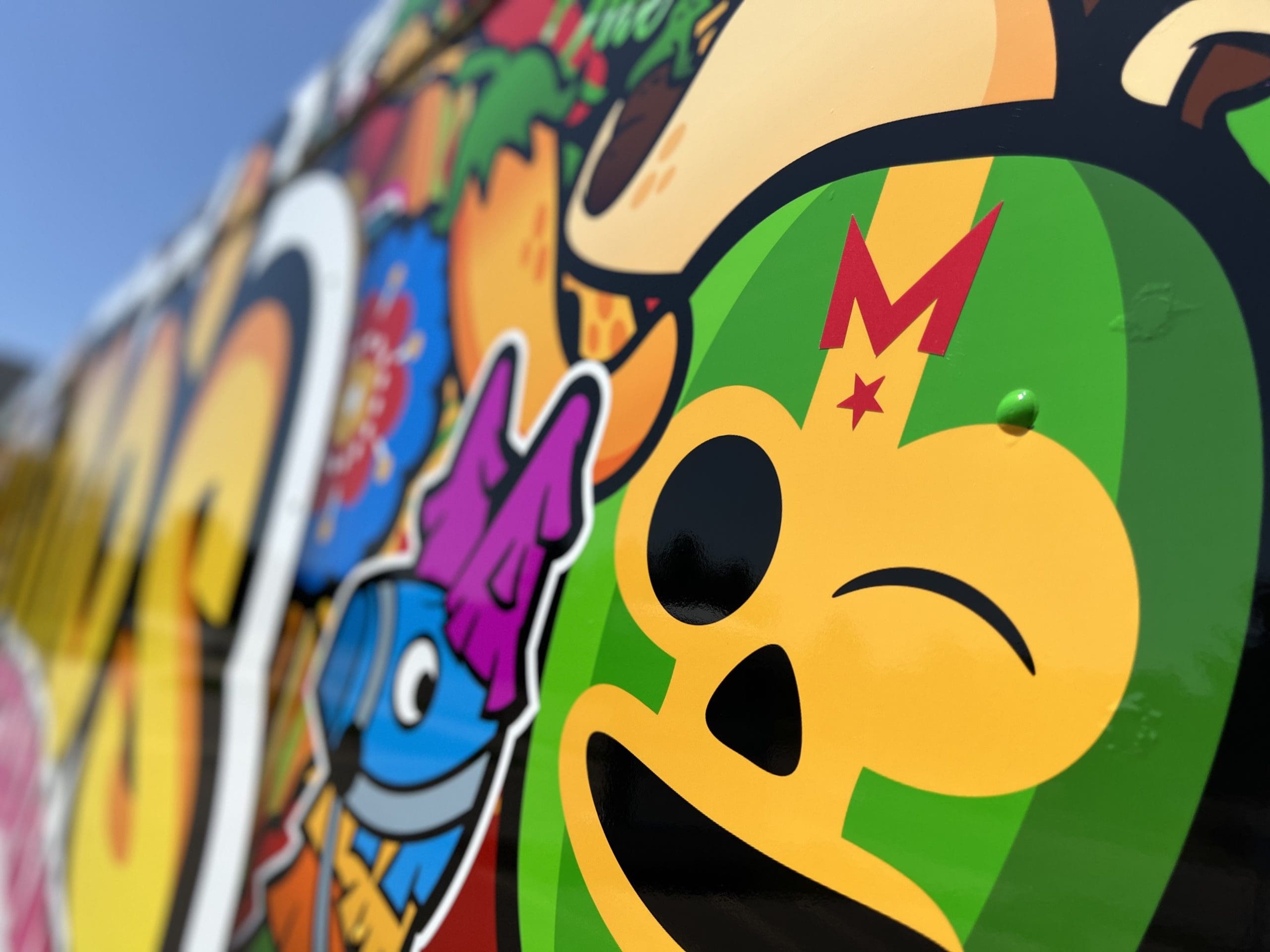 Zoom in of vehicle wrap on a food truck highlighting the Madison Graphics company small logo printed on a luchador mask