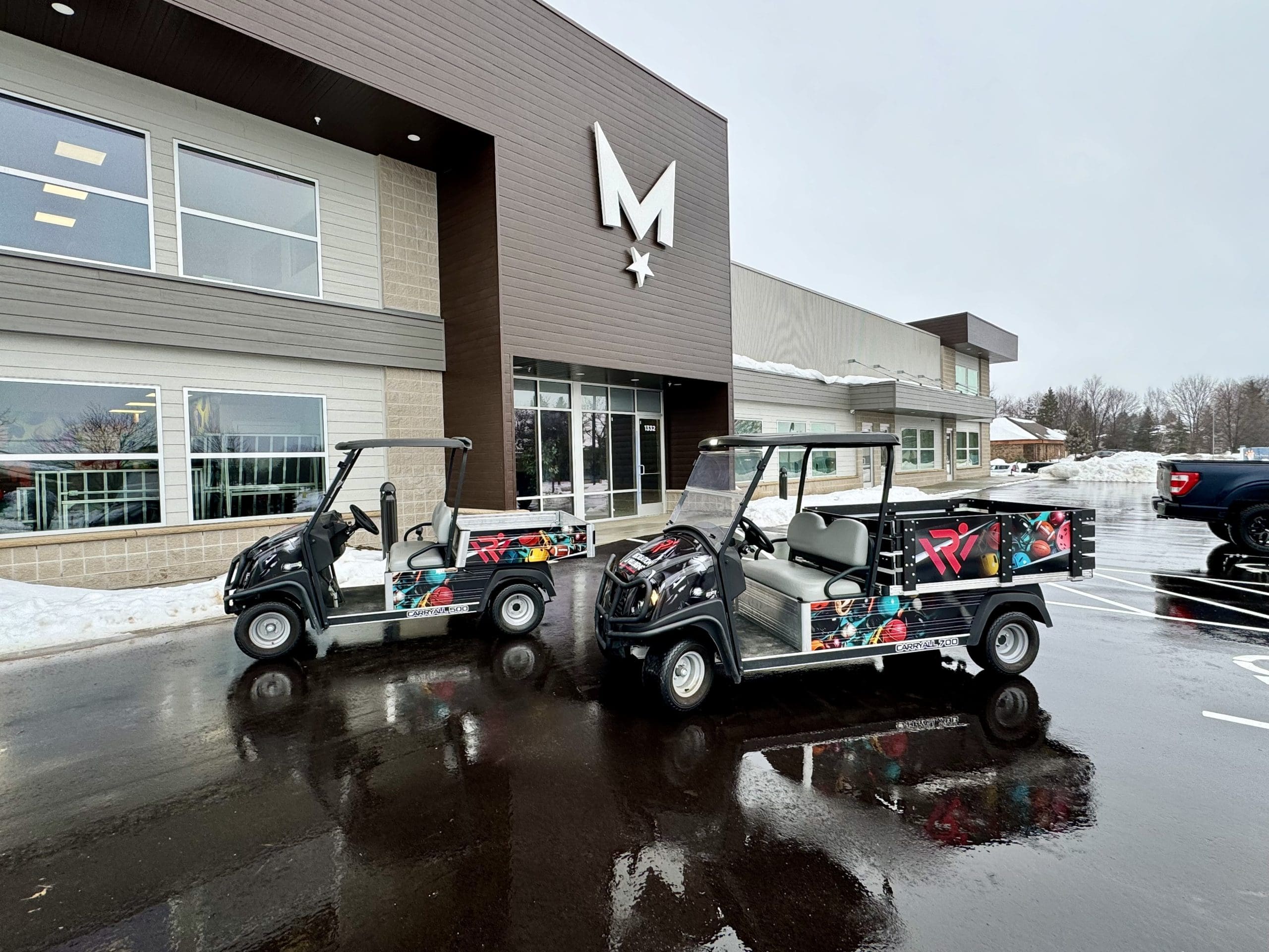 Two golf carts parked in front of Madison Graphics Company building with colorful fun bowling sports wrap on the carts.