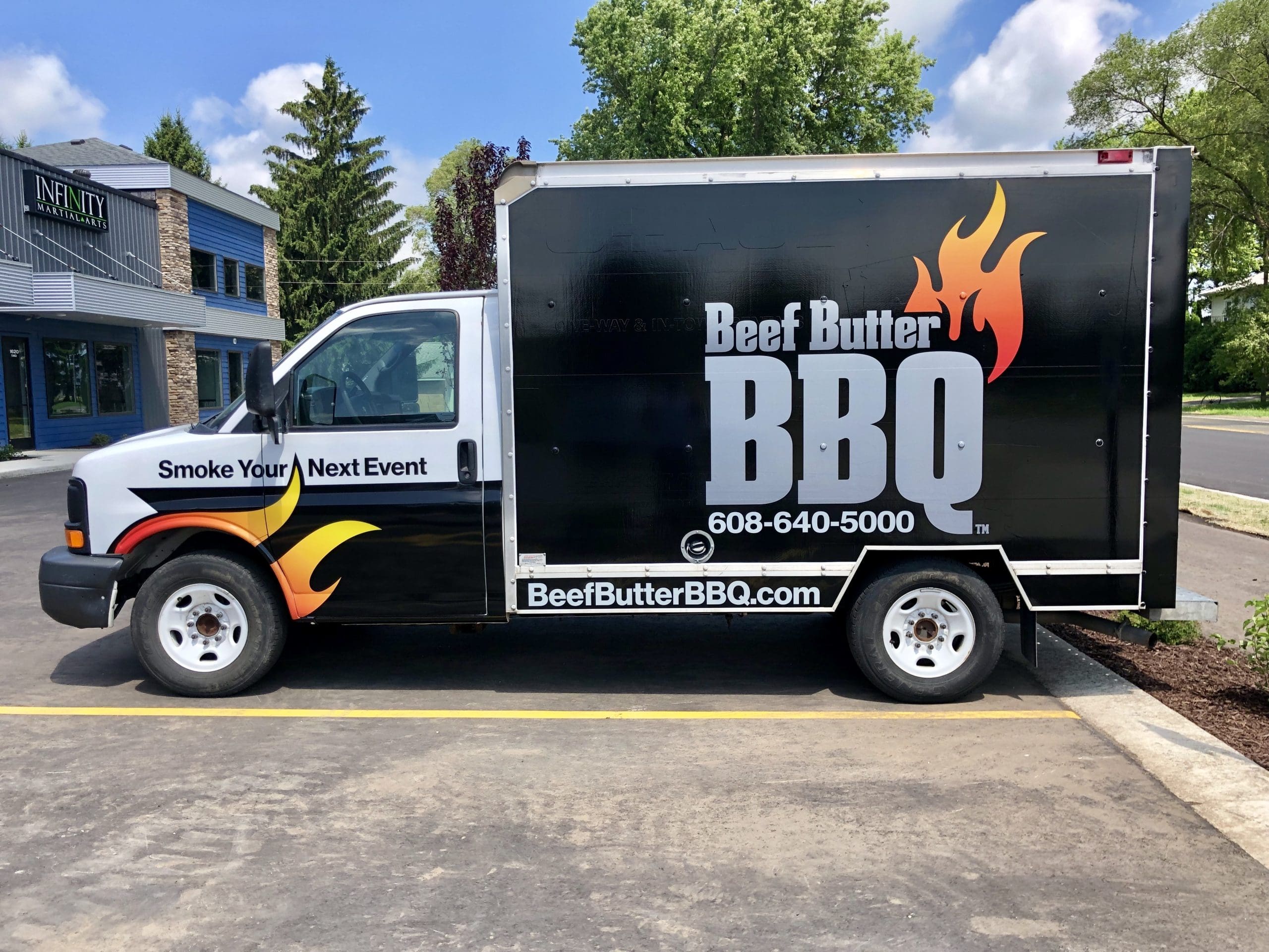 Beef Butter BBQ company truck Patio pleasures van with Fleet Graphics Vehicle wrap designed by Madison Graphics Company parked in front of the design building