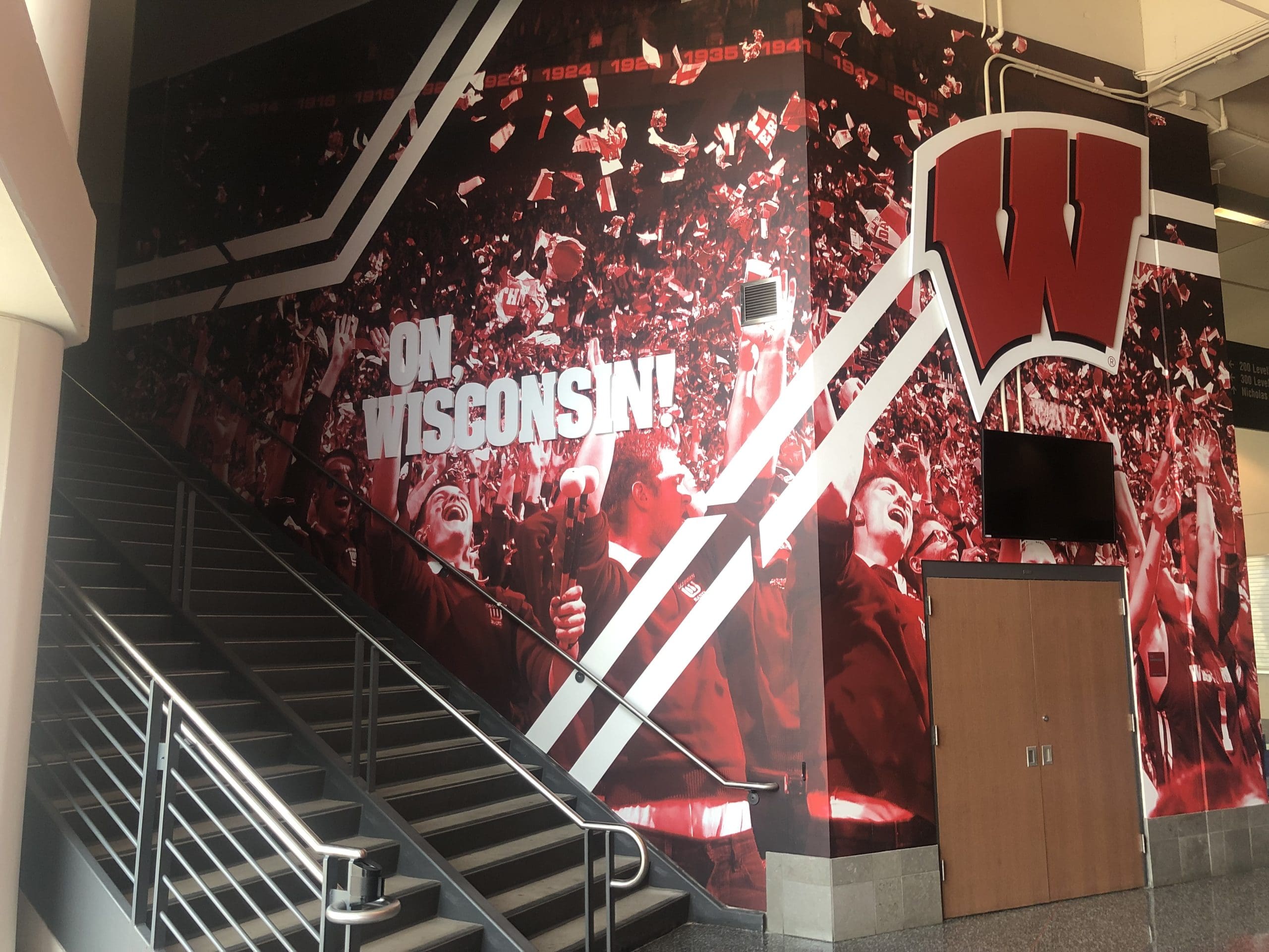 Wall Graphics for Wisconsin Badgers promoting school culture next to the stairs