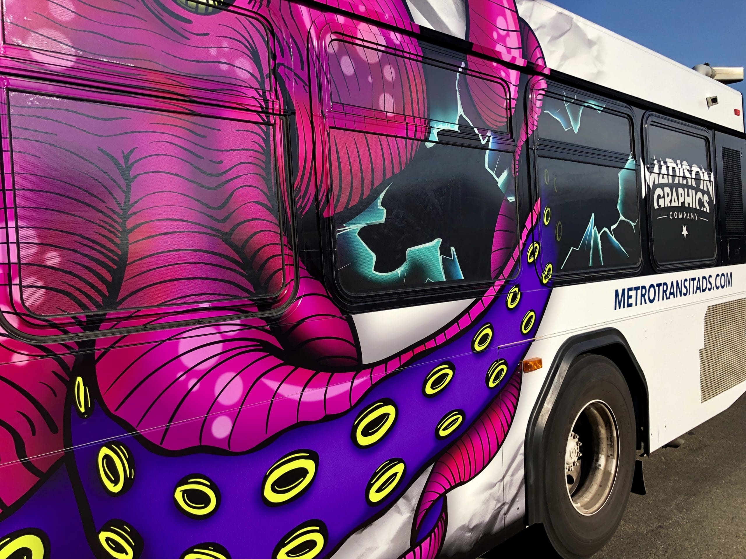 Bus with Bright pink octopus printed on the side promoting Madison Graphics Company