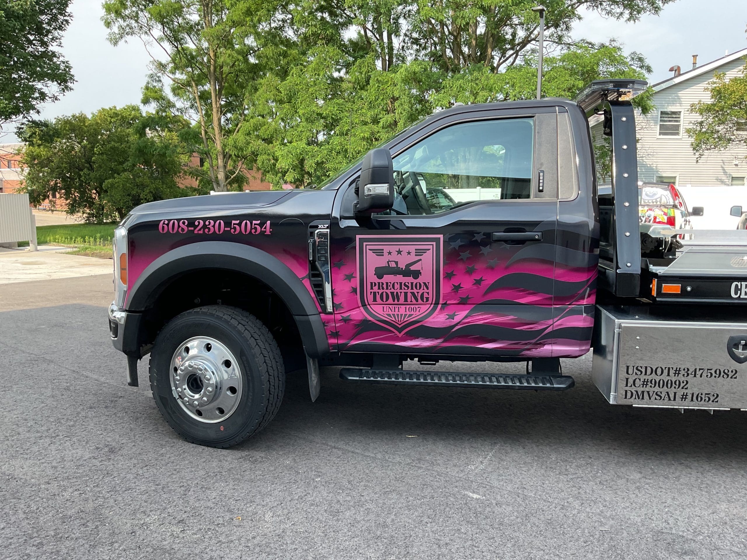 Precision Towing truck with colorful Fleet Graphics Vehicle wrap designed by Madison Graphics Company