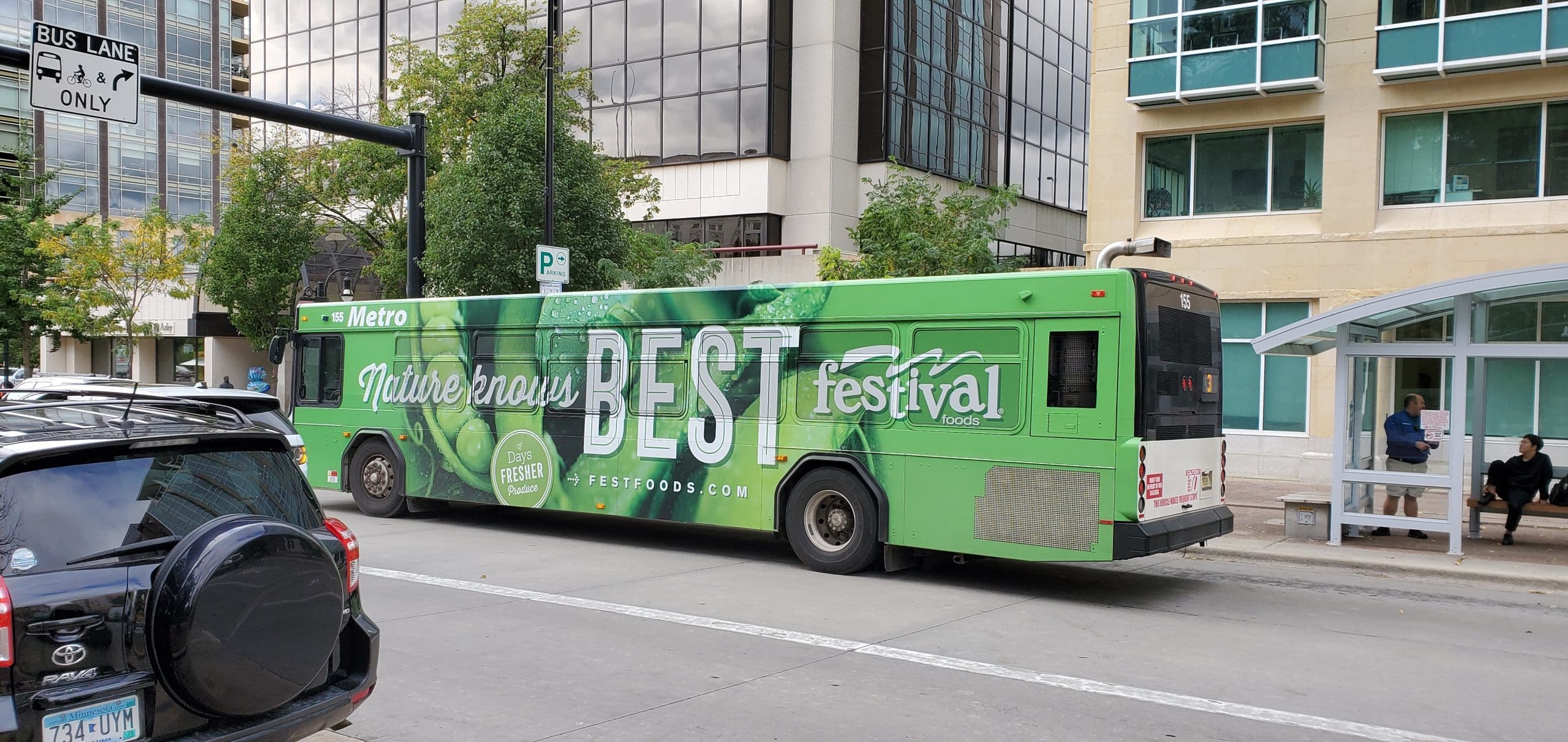 Nature knows best bright green Bus Fleet Graphics promoting Festival Foods Grocery mart