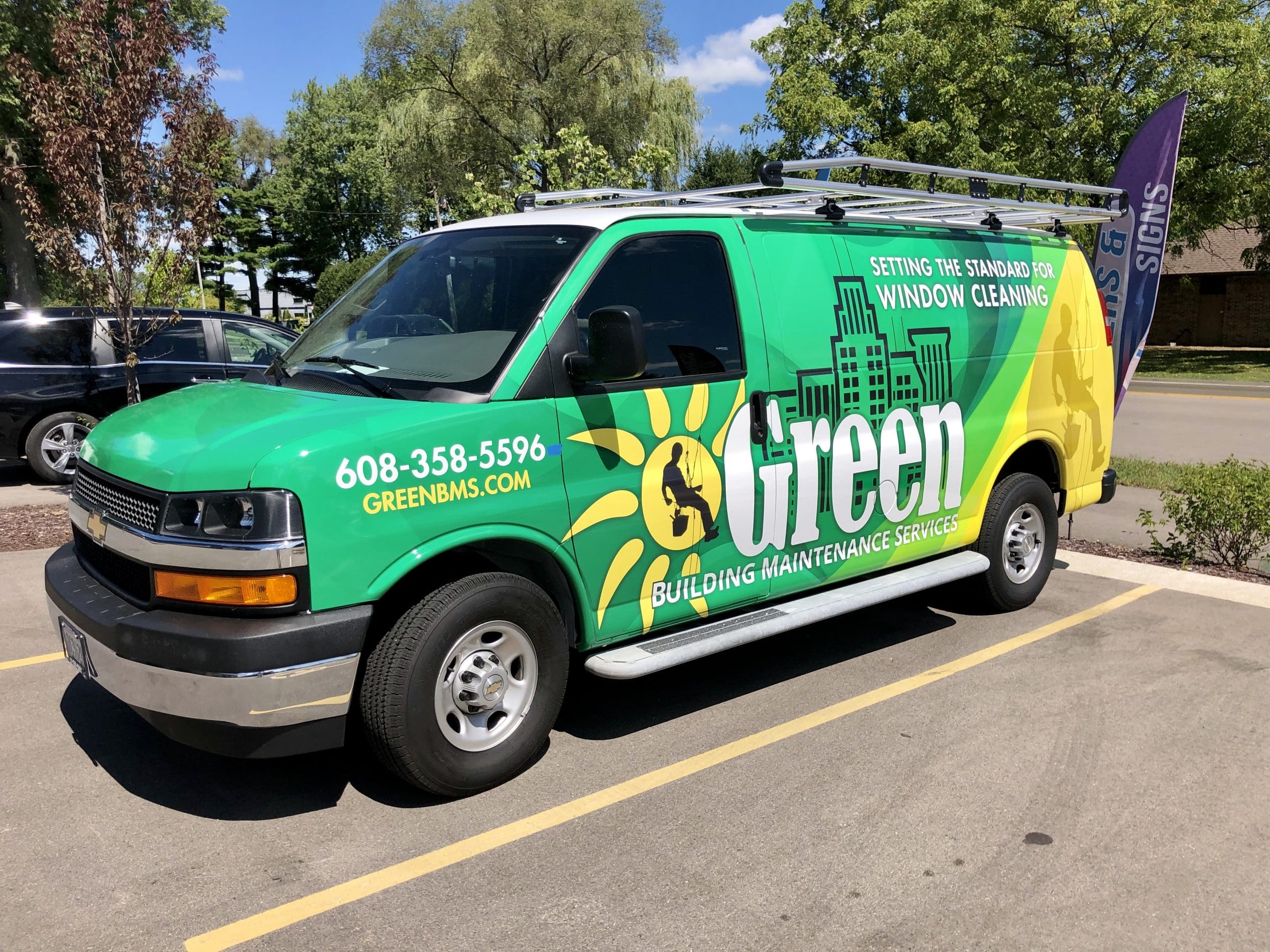 Green Building Maintenance service company van with green and yellow Fleet Graphics Vehicle wrap designed by Madison Graphics Company