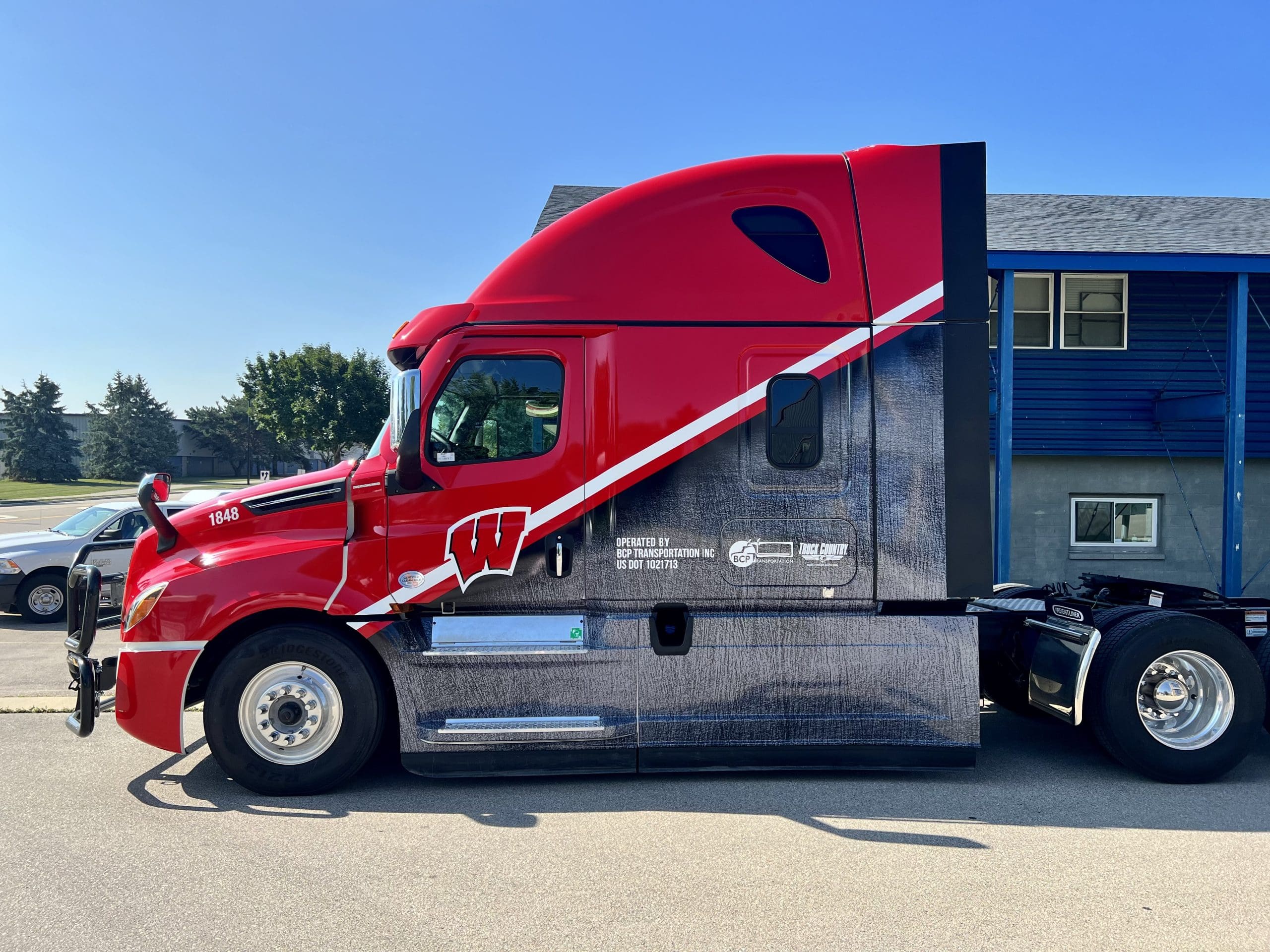 Semi truck with Wisconsin badgers design on the door with Fleet Graphics Vehicle wrap designed by Madison Graphics Company