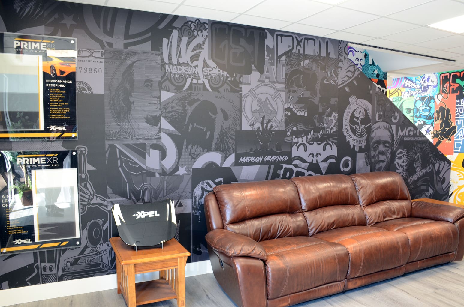 Basement of Madison graphics company with wall mural graphics and leather couch